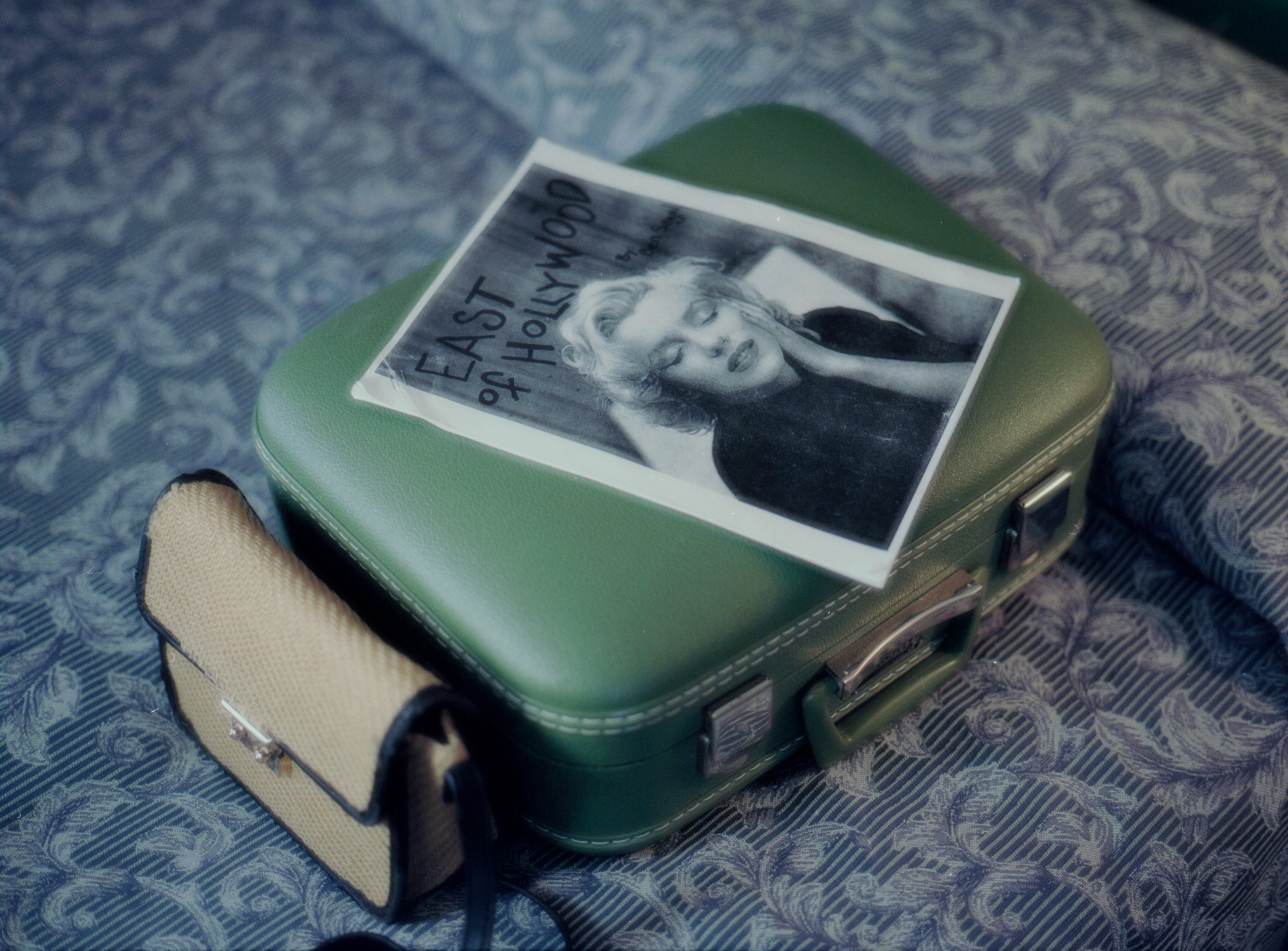 Behind the scenes - East of Hollywood zine on a vintage green suitcase